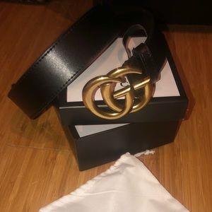 Gold and Black Gucci belt